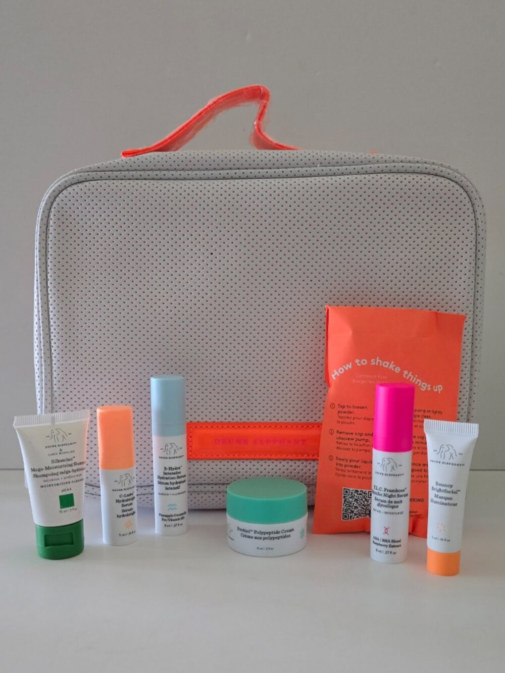 DRUNK ELEPHANT Dopp Kit with 7 travel size: shampoo, serum, cream, masque, neon